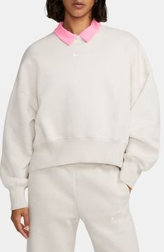 An embroidered Swoosh adds minimal branding to this cozy fleece sweatshirt cut for a relaxed, oversized fit that's enhanced by the dropped shoulders. 22" length (size Medium) Crewneck 80% cotton, 20% polyester Machine wash, tumble dry Imported Nike Phoenix Fleece, Nike Sportswear Phoenix Fleece, Blusas T Shirts, Nike Sportswear Women, Tops Nike, Wide Leg Sweatpants, Crewneck Design, Loungewear Luxury, Oversized Crewneck