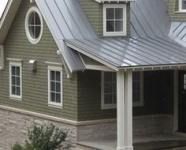 a house with a metal roof and white trim