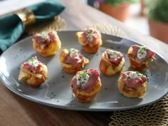 small appetizers are arranged on a silver plate