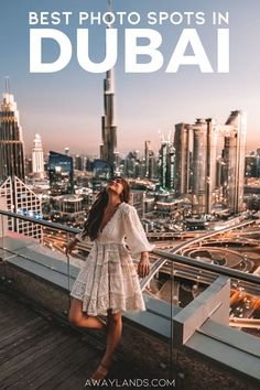 a woman standing on top of a building with the words best photo spots in dubai