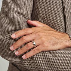 a man wearing a wedding ring on his left hand