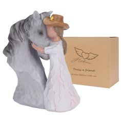 a figurine of a man and woman kissing in front of a cardboard box