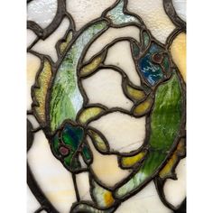 a stained glass window with green and yellow designs