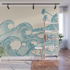 an ocean wave wall mural in a living room with wooden floors and white walls, along with potted plants