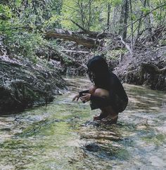 a person kneeling down in the water