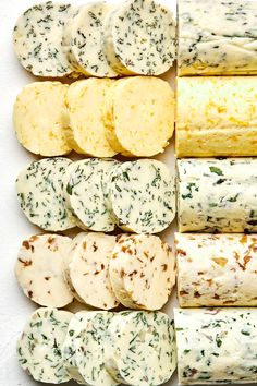 an assortment of different types of cheeses and crackers arranged in a grid pattern