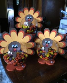 three turkeys with candy in them sitting on a table