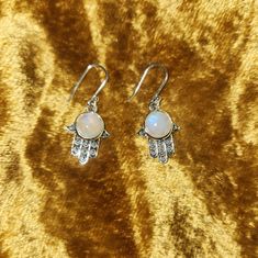 New! Colorful In Sunshine Made In India Sterling Silver Moonstone Hamsa Earrings Made In India Sterling Silver Moonstone Hamsa Earrings The Hand (Khamsa), Particularly The Open Right Hand, Is A Sign Of Protection That Also Represents Blessings, Power And Strength, And Is Seen As Potent In Deflecting The Evil Eye. Moonstone Cultivates Compassion And Empathy Towards Yourself And Others. It Helps You To Tap Into Your Intuition To Help You See Situations More Clearly. Moonstone Is Good For Activatin White Spiritual Jewelry With Matching Earrings, White Crystal Pierced Earrings As Gift, White Pierced Crystal Earrings As Gift, White Pierced Crystal Earrings For Gifts, Handmade White Crystal Round Earrings, Handmade White Crystal Earrings, White Round Pierced Crystal Earrings, White Spiritual Teardrop Earrings, White Gemstone Crystal Dangle Earrings