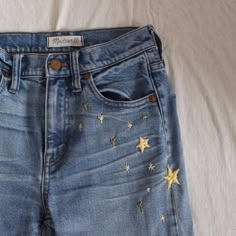 a pair of blue jeans with gold stars on them