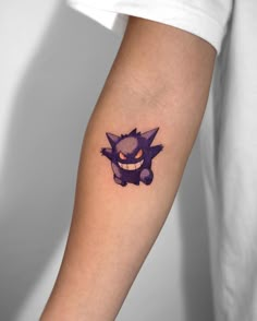 a person with a tattoo on their arm that has an image of a cat in it