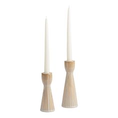 two white candles sitting next to each other