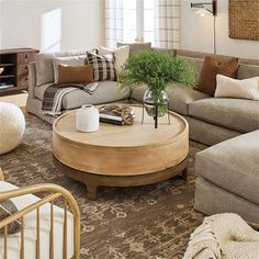 a living room filled with lots of furniture and decor on top of a wooden table