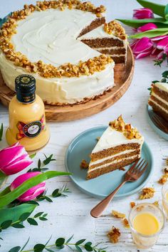 there is a piece of cake on the plate next to two glasses and a bottle