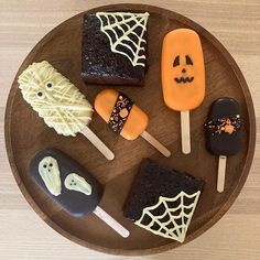 halloween treats are arranged on a wooden plate