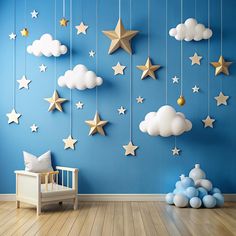 a baby's room with stars and clouds hanging from the ceiling