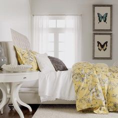 a bedroom with white furniture and yellow bedding