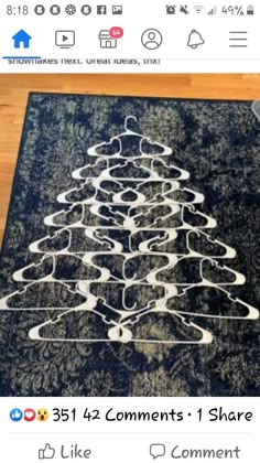 a black and white christmas tree rug on top of a wooden floor