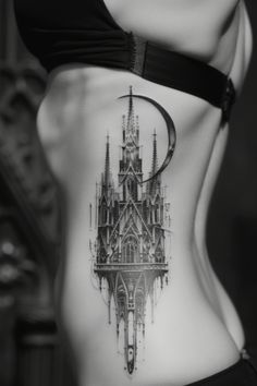 a woman's stomach with a tattoo on it that has an image of a cathedral