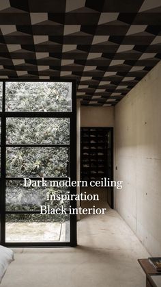 a bedroom with black and white tiles on the ceiling, windows open to let in natural light