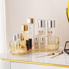 an assortment of skin care products sitting on a counter next to a mirror and clock