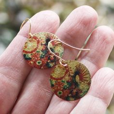 Groovy Bloom coin earrings with an etched and printed design of colorful blooms on a gold finish charm. They are lightweight and colorful with a textured surface with a subtle shimmer. Gold plated earwires. Earrings measure 1 1/4" from the top of the earwire. Find more great earrings here http://www.etsy.com/shop/everybeadofmyart?section_id=8084100 Thanks for shopping Every Bead of My Art! Multicolor Brass Earrings For Festivals, Hand Painted Gold Earrings For Festival, Gold Hand Painted Earrings For Festivals, Artsy Gold Earrings Made Of Copper, Artsy Gold Copper Earrings, Bohemian Hand Painted Brass Earrings, Hand Painted Copper Bohemian Earrings, Bohemian Hand Painted Copper Earrings, Gold Earrings With Artistic Design For Festivals