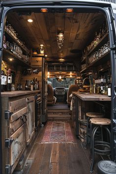 the inside of an old van with wooden floors and tables in it's back door