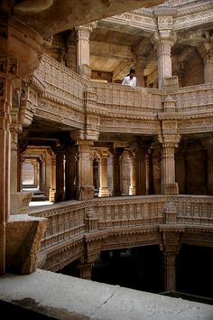 a man standing in the middle of an ornate building