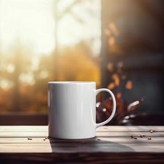 a white coffee cup sitting on top of a wooden table