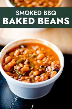 two bowls filled with baked beans on top of a black surface and the words smoked bbq baked beans above them