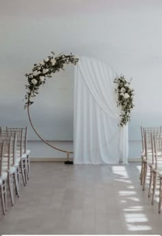 the ceremony room is decorated with white flowers and greenery