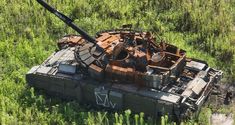 an old tank sitting in the middle of a field