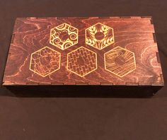 a wooden box with four different designs on it