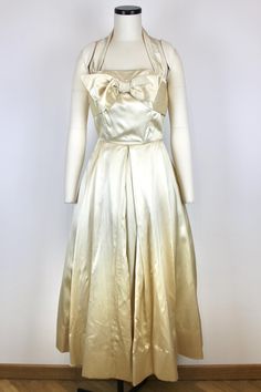 Seductive 1950s Off White Silk Dress No brand or size tags, couture item Origin: Italy Fits like: S Measurements: Bust - 87cm/34,3" Waist - 66cm/26" Displayed on mannequin with the following measurements: Bust 80 cm (31.5) Waist 63 cm (24.8") Hips 91 cm (35.8") Condition: Very Good, there were some light stains on the armpits but we have rearranged the pleats so they are much less noticeable. 1950s Style A-line Vintage Wedding Dress, 1950s Style Cream Evening Dress, Vintage Satin Dress For Vintage Events, Vintage Satin Evening Dress, 1950s Evening Dresses With Fitted Bodice, Vintage Silk Evening Dress With Fitted Bodice, Vintage Satin Evening Dress With Fitted Bodice, Cream Vintage Dress For Party, Cream Vintage Party Dress