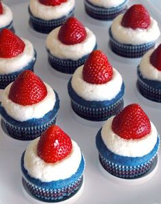 cupcakes with white frosting and strawberries on top