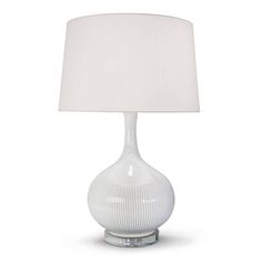 a table lamp with a white shade on the base and a light bulb attached to it