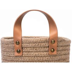 a brown basket with leather handles