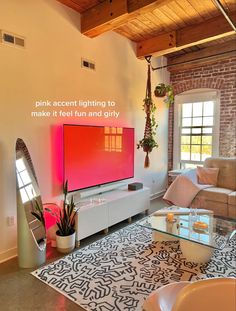 a living room with a large flat screen tv on the wall next to a couch