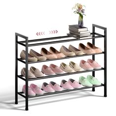 there is a rack with many pairs of shoes on it and a flower in a vase