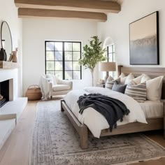 a bedroom with a large bed and fireplace