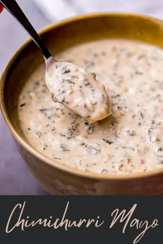 there is a spoon full of soup in a bowl with the words cheesy mayo on it