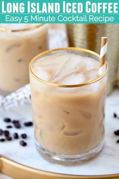 two glasses filled with iced coffee sitting on top of a table