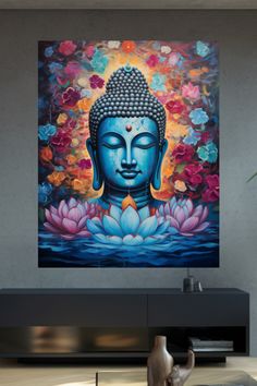 a buddha statue sitting on top of a table next to a vase filled with flowers