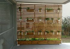 a wooden fence with plants growing on it