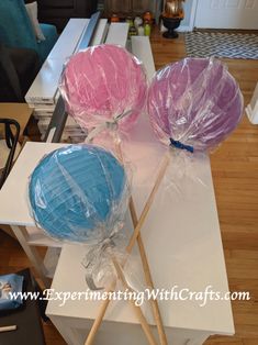 two lollipops wrapped in plastic sitting on top of a table