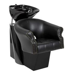 a black leather chair with studded trimmings and a bowl on the back