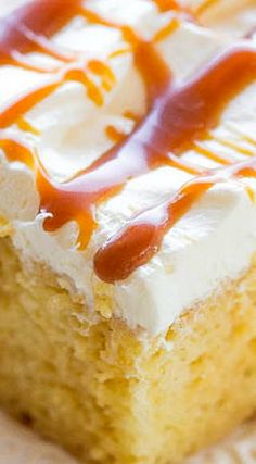 a piece of cake with white frosting and caramel drizzle on top