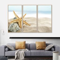 three seashells and starfish on the beach with sand