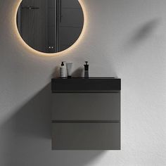 a bathroom with a sink, mirror and light on the wall above it's counter