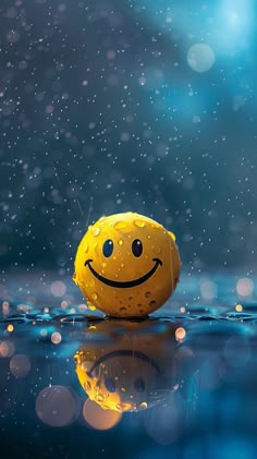 a yellow smiley face floating on top of water with rain falling around it and blue sky in the background