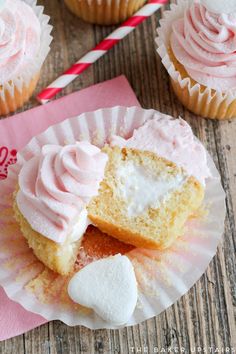 cupcakes with pink frosting and heart shaped marshmallows